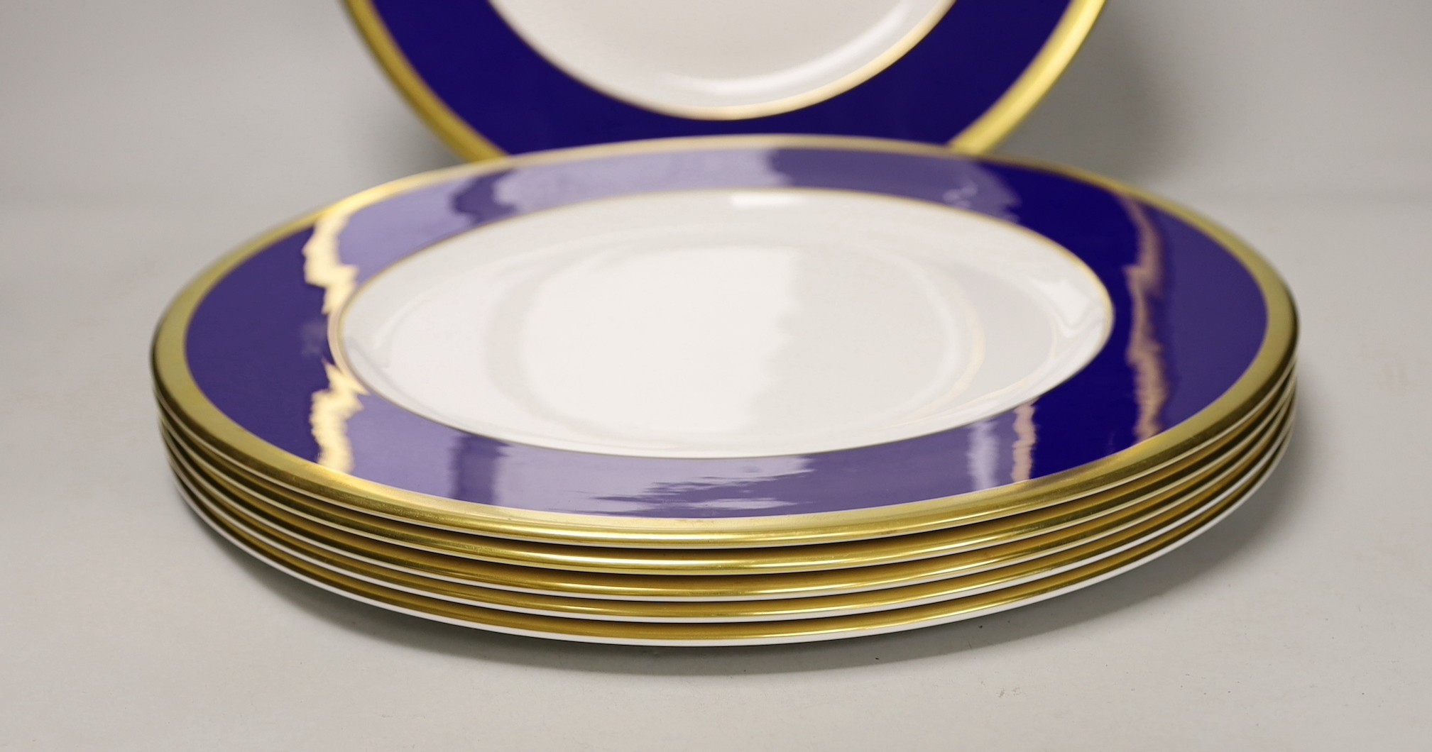 Six Asprey, London, blue and gilt banded dinner plates, 34cms diameter